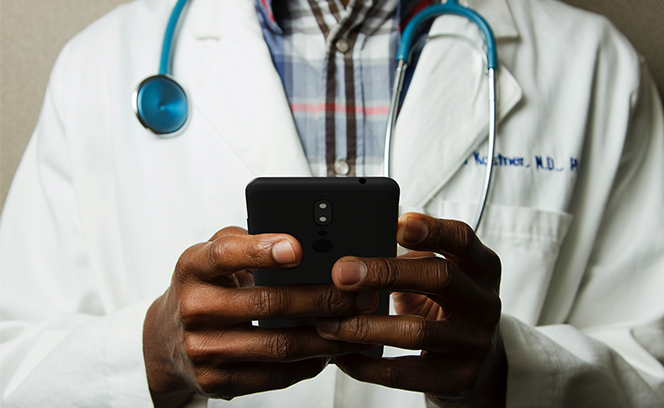 doctor holding mobile device